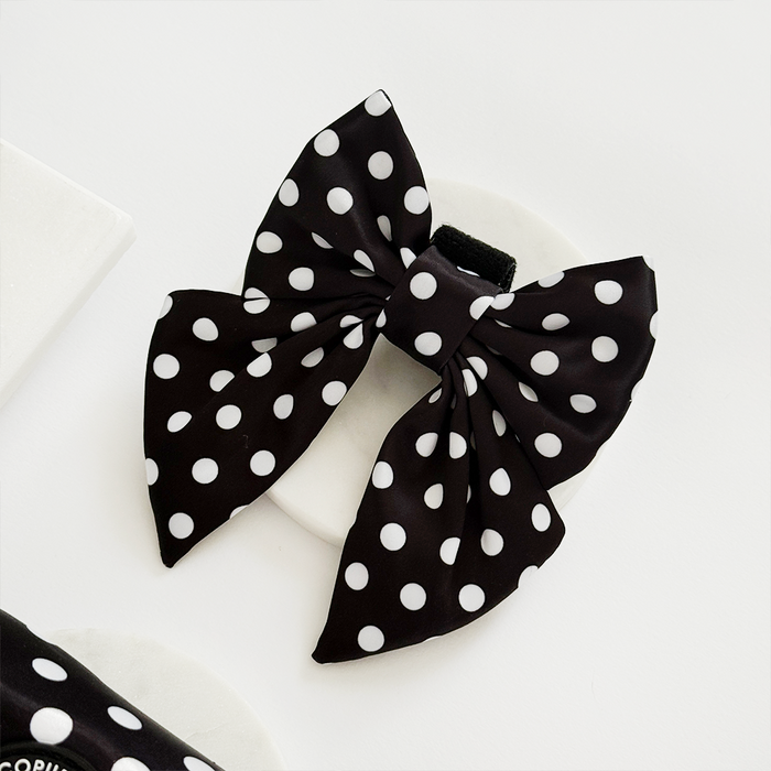 Polka dot sailor bow tie by Cocopup London, black with white spots, displayed on a plain white background.