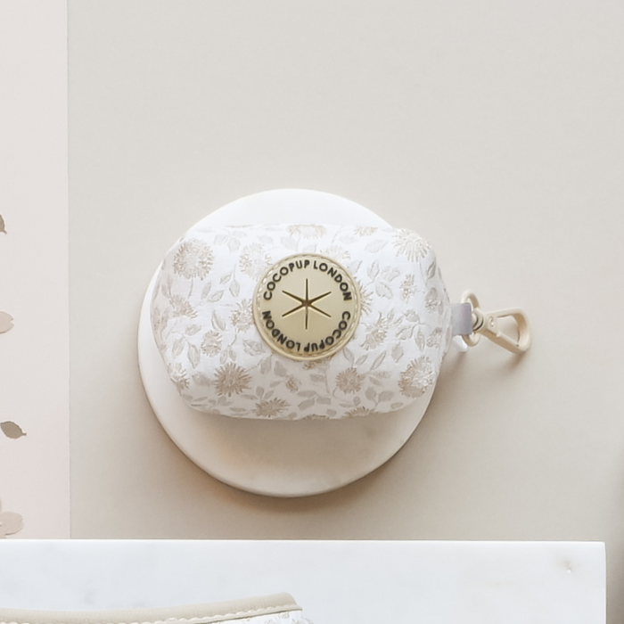 White floral print poop bag holder with gold logo detailing by Cocopup London.