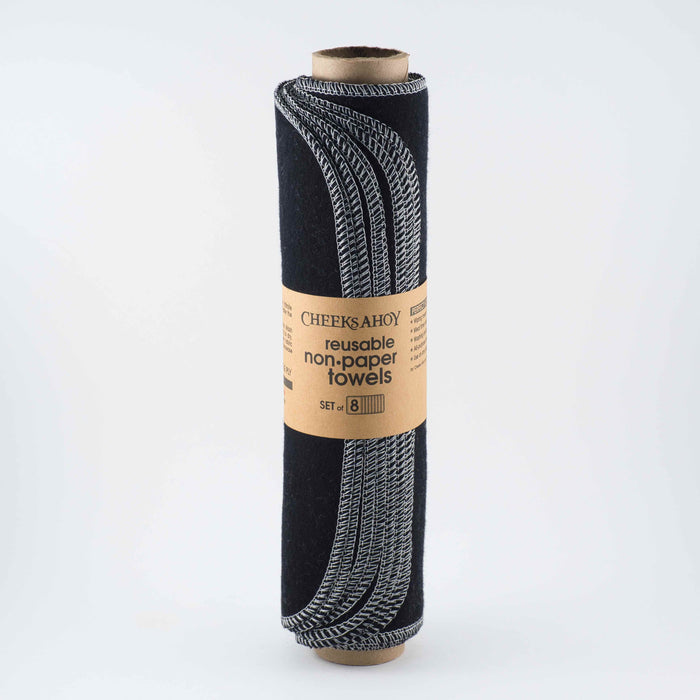 A set of pre-rolled reusable non-paper towels in a variety of solid colors, rolled up on a paper towel tube.