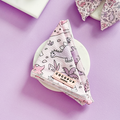 Pink Cocopup London Princess Dino dog bandana, folded on a white surface with a purple background.