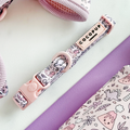 Pink harness, lead, and collar set with cartoon dinosaur pattern from Cocopup London.