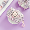 Pink poop bag holder with cute dinosaur print and gold clip by Cocopup London.