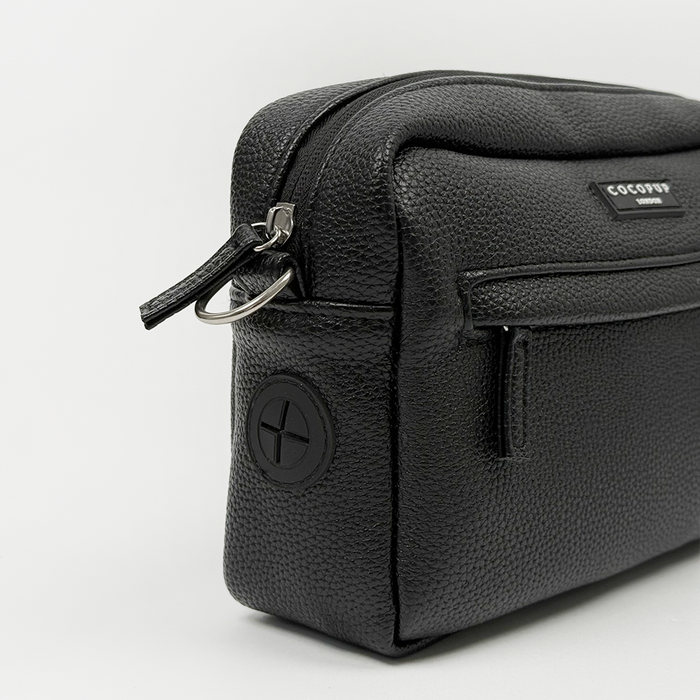 Black PU leather dog walking bag with front zipper and circular side logo from Cocopup London.