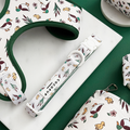 Green and white dog collar with cartoon ducks, leaves, and mushrooms pattern by Cocopup London.