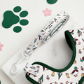 White dog leash with yellow duck pattern, neoprene handle, and paw and flower cutout details.