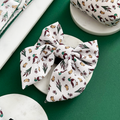 Puddle Pup Sailor Bow Tie by Cocopup London featuring a playful duck and acorn print, displayed on a white surface.