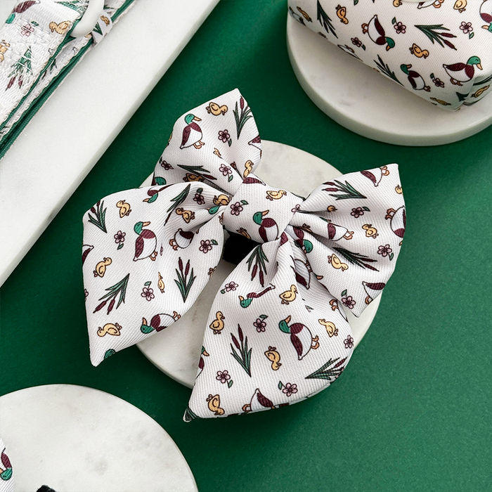 Puddle Pup Sailor Bow Tie by Cocopup London featuring a playful duck and acorn print, displayed on a white surface.