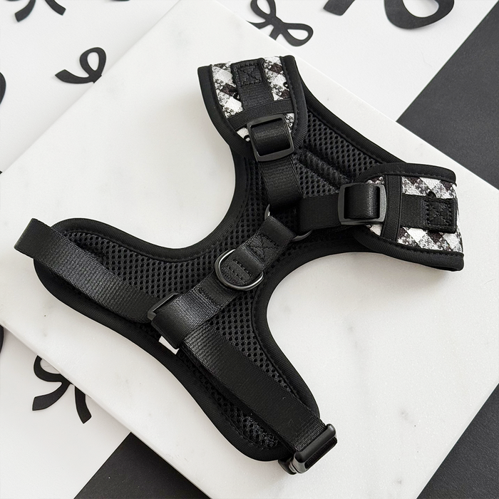 Pink Pup in Paris harness, lead, and collar bundle with gold hardware displayed on a decorative patterned surface.