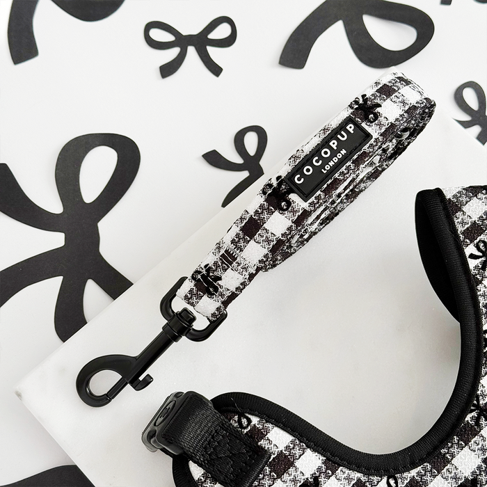 Pink and white checkered harness, lead, and collar set from Cocopup London with gold hardware.
