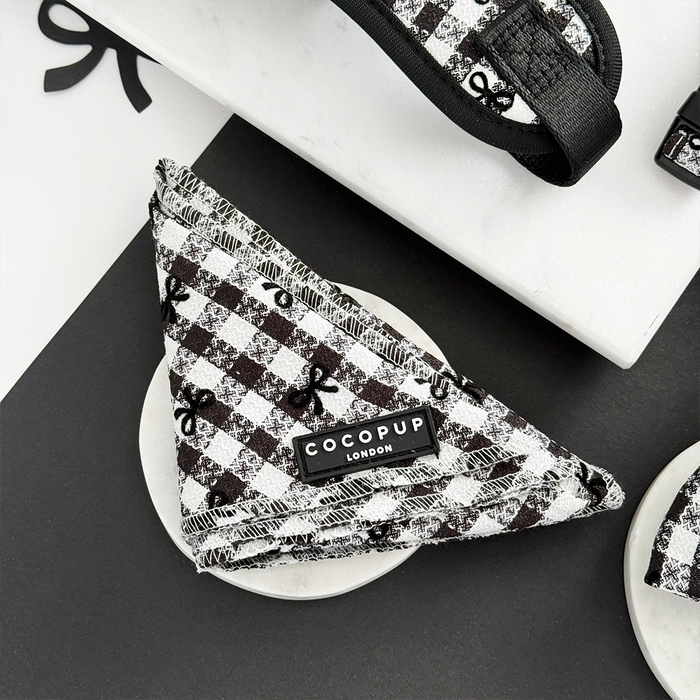 Black and white check bandana with Cocopup London label, displayed on a white marble surface.