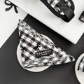 Black and white check bandana with Cocopup London label, displayed on a white marble surface.