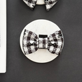 Cocopup London Pup in Paris Bow Tie with black and white checkered pattern and musical note accents.