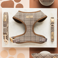 Plaid dog harness, lead, and collar set from Cocopup London shown on marble with a warm-toned background.