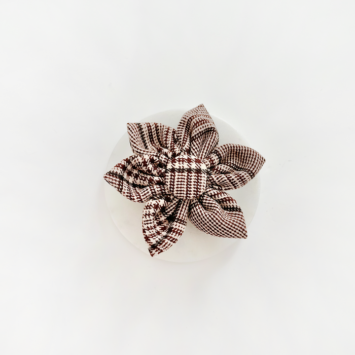 Brown and white plaid flower-shaped collar accessory for dogs.
