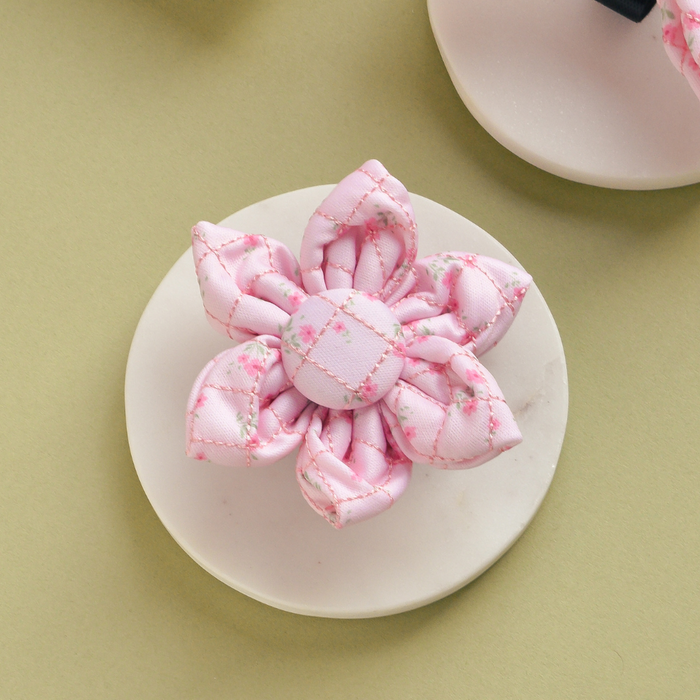 Cocopup London pink collar flower with quilted ditsy floral pattern on a white surface, beige background.