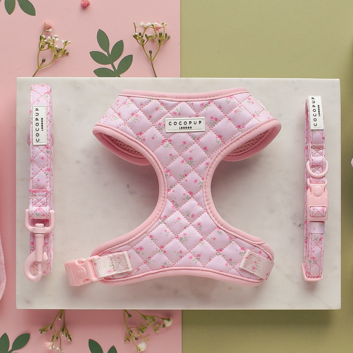 Pink quilted floral dog collar by Cocopup London on a pastel background with small flowers.