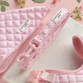Quilted pink floral dog lead from Cocopup London on a marble and pink background.