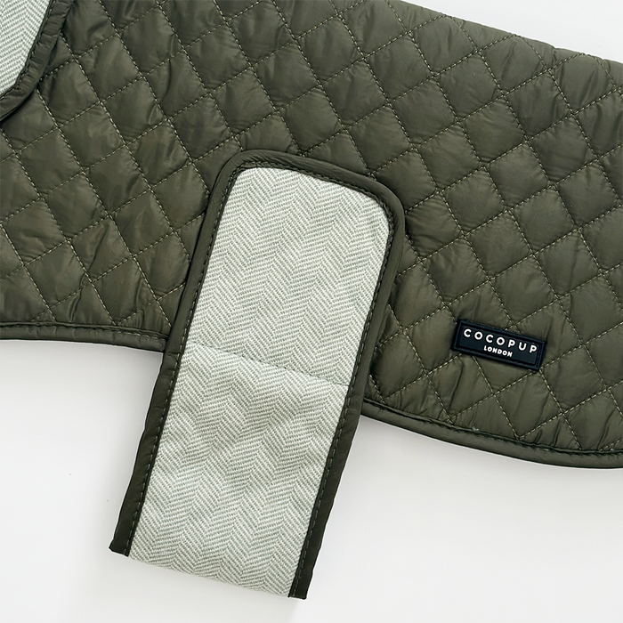 Country khaki quilted dog coat with a herringbone strap, teddy lining, and Cocopup London brand label.