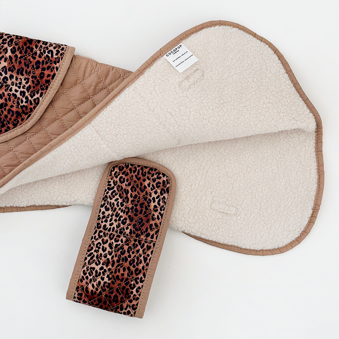 Tan quilted saddle pad with leopard print trim and girth cover, matching a leopard print Cocopup London dog coat.