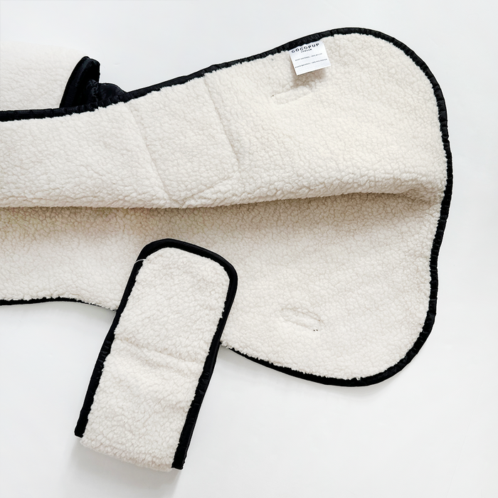 Cocopup London quilted dog coat in midnight black, shown lying flat on a white background.