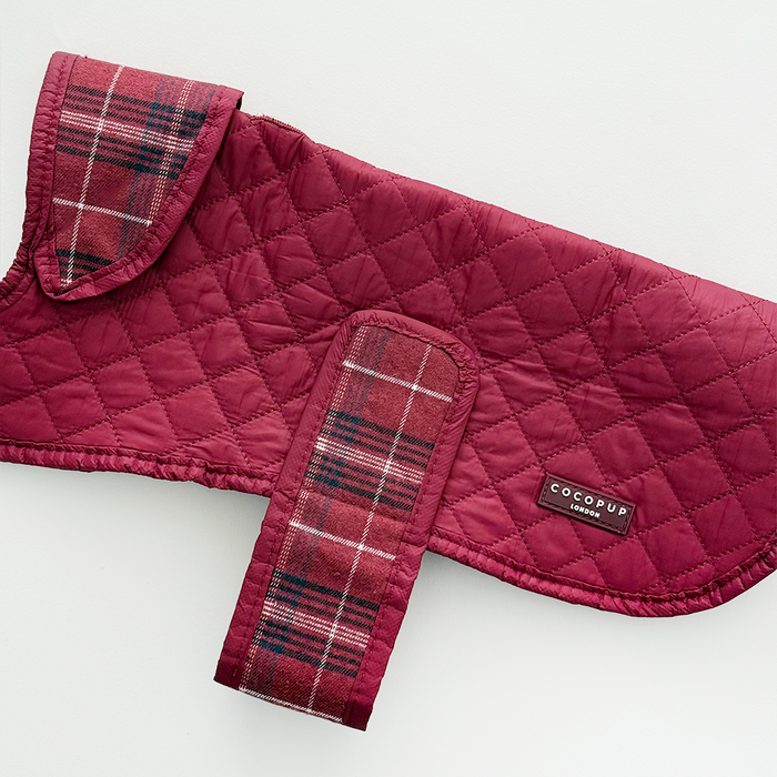Quilted dog coat in mulberry plaid with a soft finish, featuring Cocopup London branding.