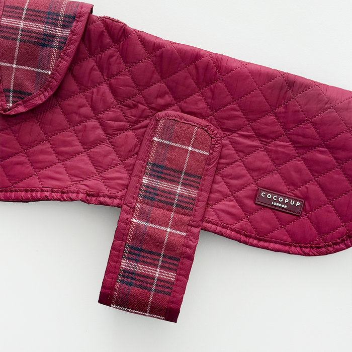 Cocopup London quilted dog coat in mulberry plaid with Velcro strap, featuring a soft, padded finish.