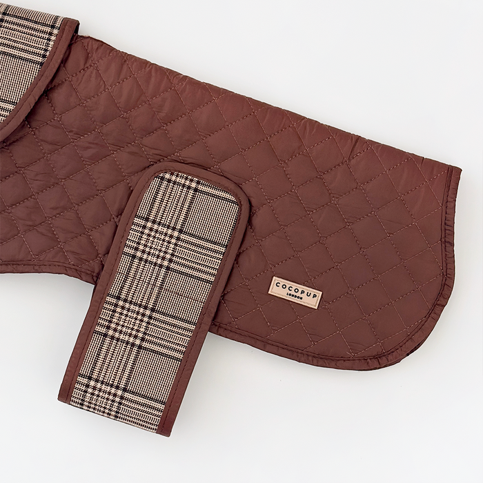 Quilted dog coat in pup plaid with teddy fleece lining and Cocopup label, shown against a white background.