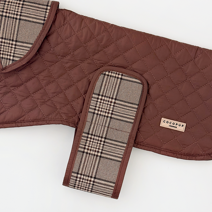 Brown quilted dog coat with plaid trim and soft Teddy lining.