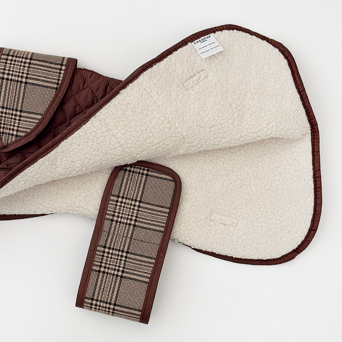 Quilted dog coat with brown trim, soft teddy lining, and plaid strap in Cocopup London’s Pup Plaid pattern.