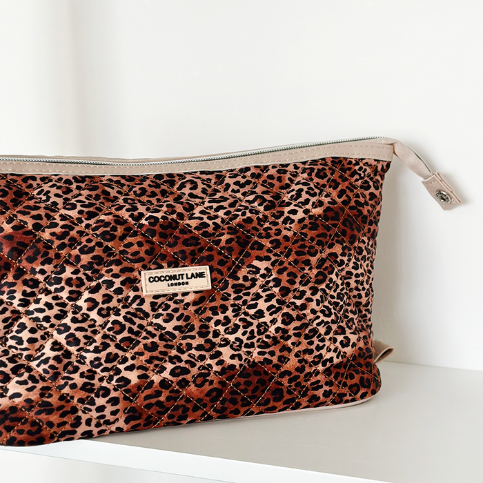 Expandable makeup bag with a quilted leopard print pattern and gold zipper, by Cocopup London.