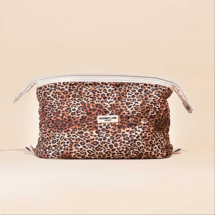 Expandable quilted makeup bag with a leopard print, by Cocopup London, set against a plain beige background.