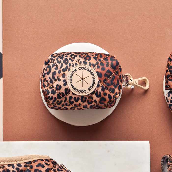 Quilted leopard print poop bag holder with gold zipper, metal clip, and Cocopup London logo.