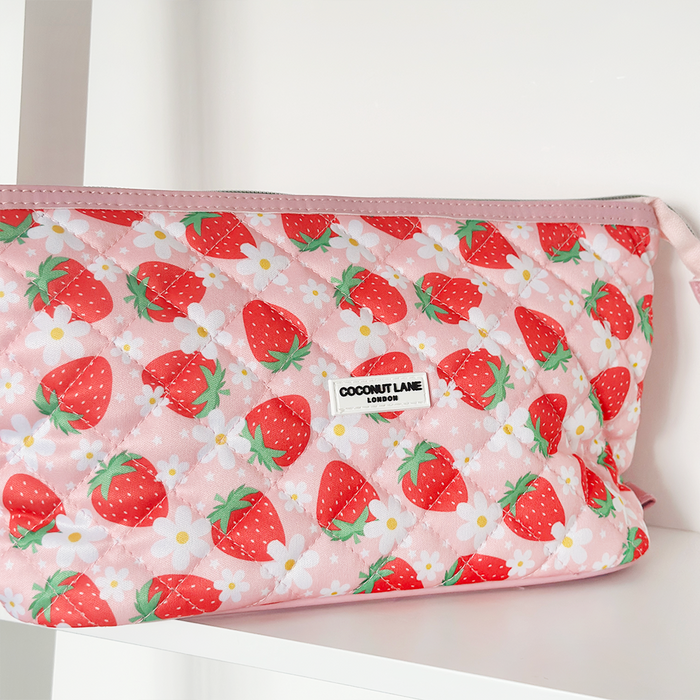 Quilted expandable makeup bag with pink strawberries and white daisies pattern, by Cocopup London.
