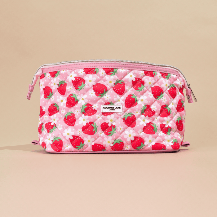 Pink quilted makeup bag with a strawberry and flower print, front zipper.