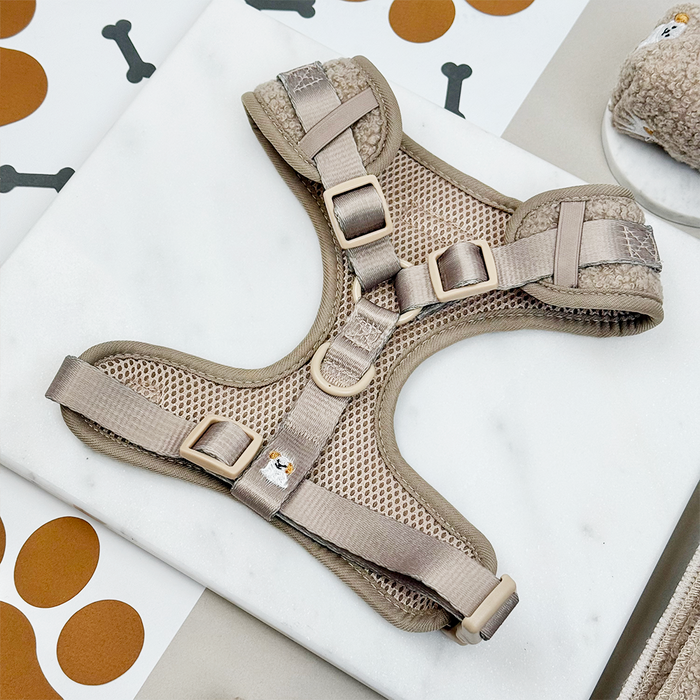 Mocha teddy adjustable neck harness with Ralph & Friends print on white marble, surrounded by dog-themed decor.