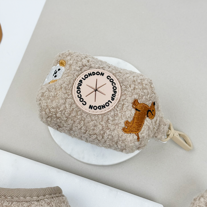 Fluffy beige poop bag holder with teddy bear design and gold clip, branded by Cocopup London.