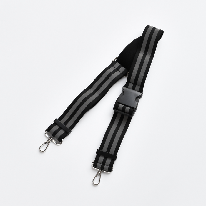 Black Cocopup London reflective bum bag strap with metal hooks and a plastic buckle on a white background.