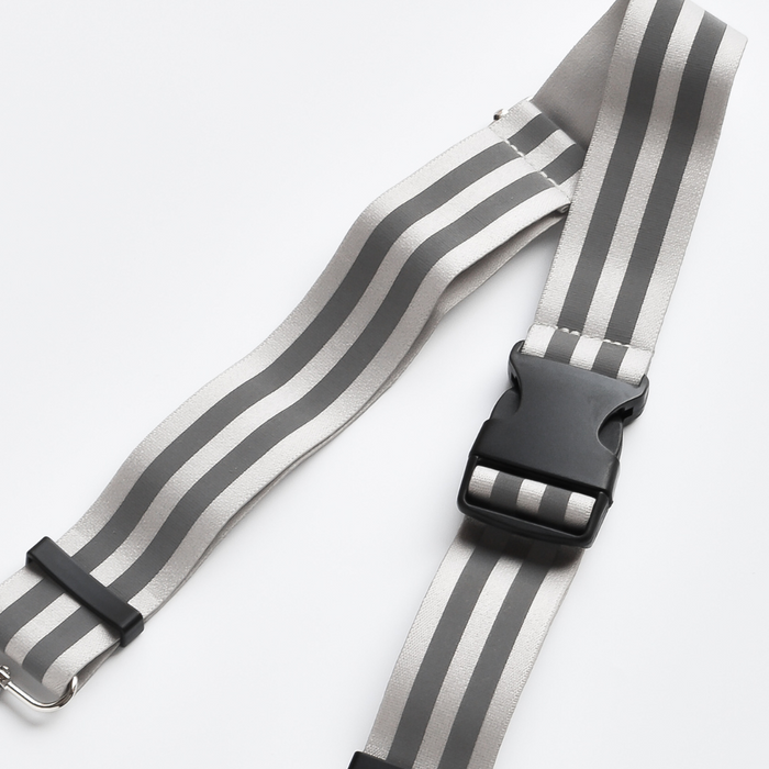 Nude-colored reflective bum bag strap with silver hardware and Cocopup London branding.