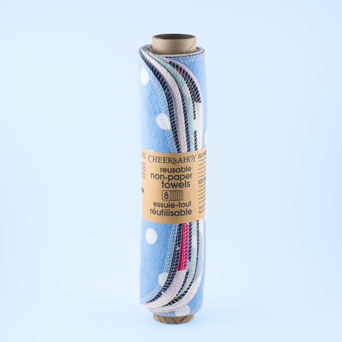 Roll of reusable non-paper towels with colorful patterns on a light blue background