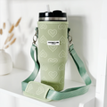 Sage green tumbler carry case with embossed heart pattern, sized for a 40oz Stanley Quencher.