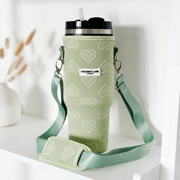 Sage green tumbler carry case with embossed heart pattern, sized for a 40oz Stanley Quencher.