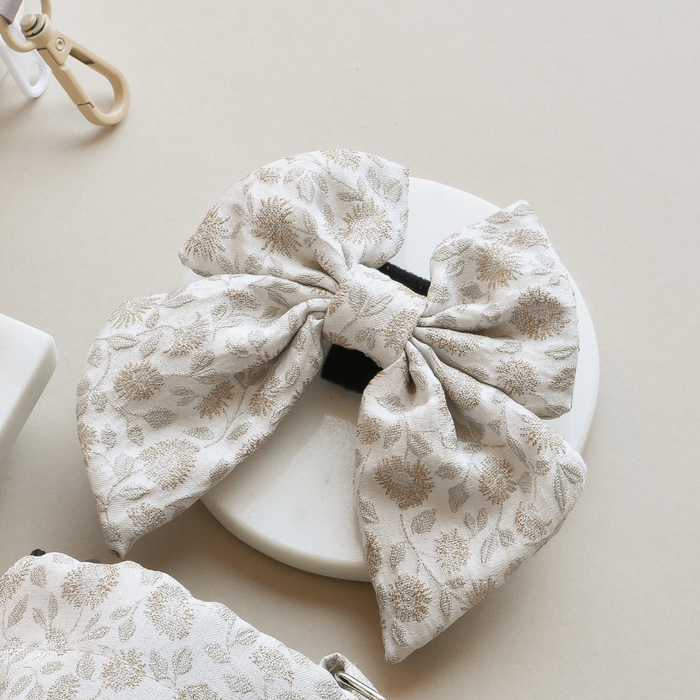 Cream floral dog bow tie with sailor style from Cocopup London, featuring a soft fabric and garden meadow pattern.