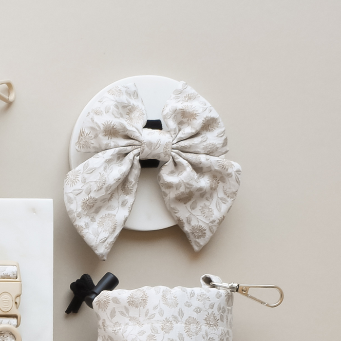 Green floral bow tie and matching pouch from Cocopup London displayed side by side.
