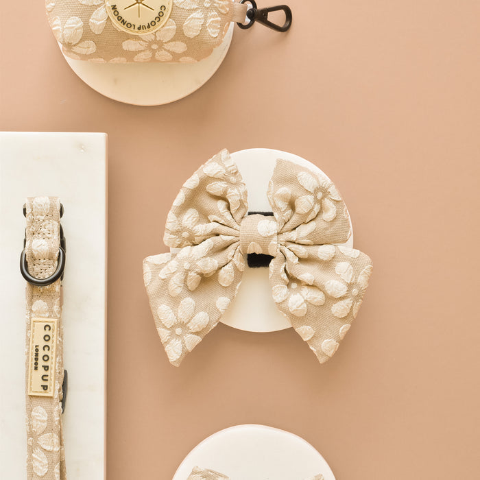 Mocha flower-patterned Luxe Sailor Bow Tie by Cocopup London on a card next to a matching collar.