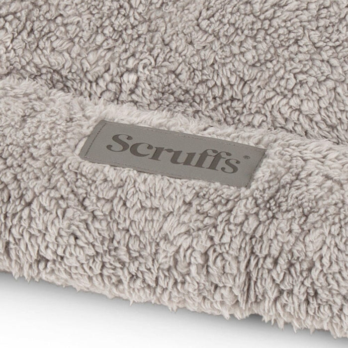 Close-up of the Scruffs Cosy Crate Mat plush fabric and embroidered logo