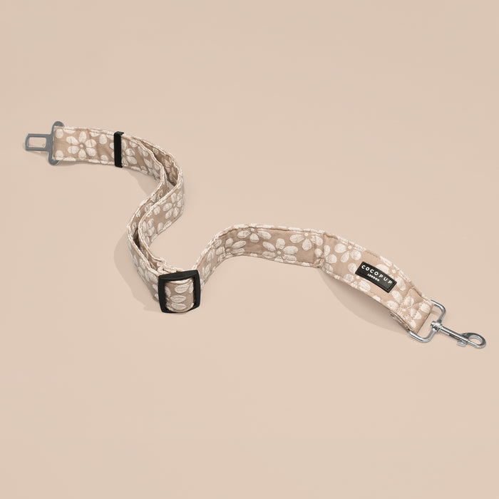 Mocha Flower Cocopup London dog seat belt restraint with metal clip and buckle on a neutral background.