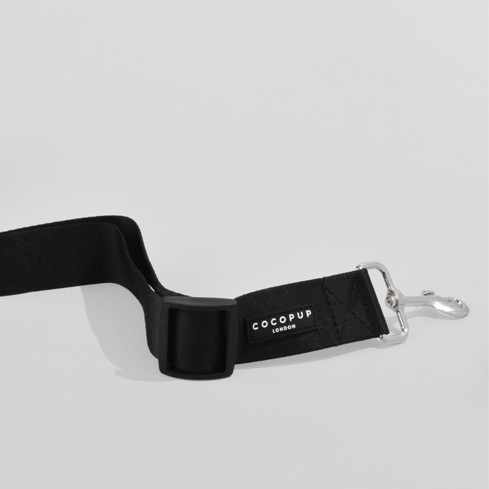 Plain black Cocopup London seat belt restraint with a sturdy metal clasp.