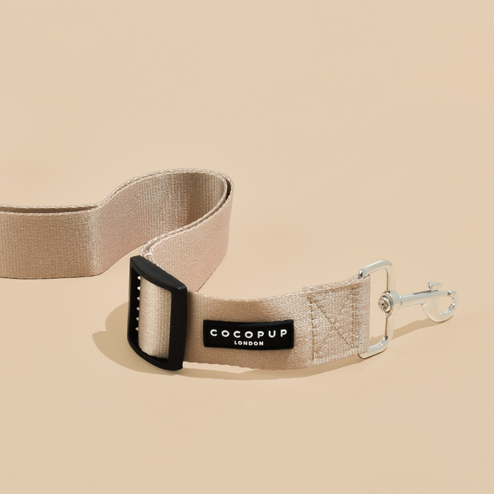 Cocopup London dog seat belt restraint in solid nude color with metal clip and adjustable buckle.