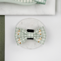 Green and white check print dog bow tie with embroidered geese design.