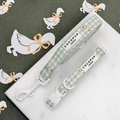 Green and white check print dog lead and collar with embroidered geese design.